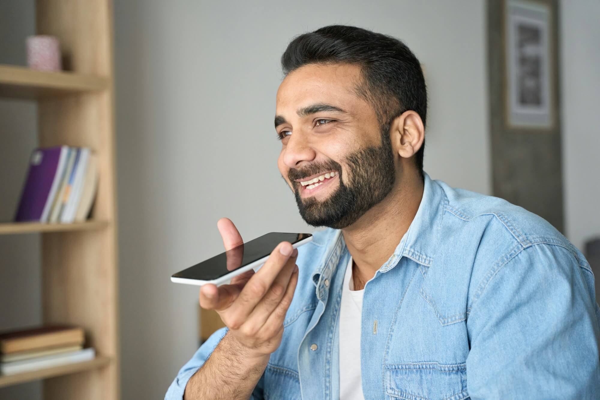 young-indian-man-speaking-to-voice-assistant-using-smartphone-.jpg